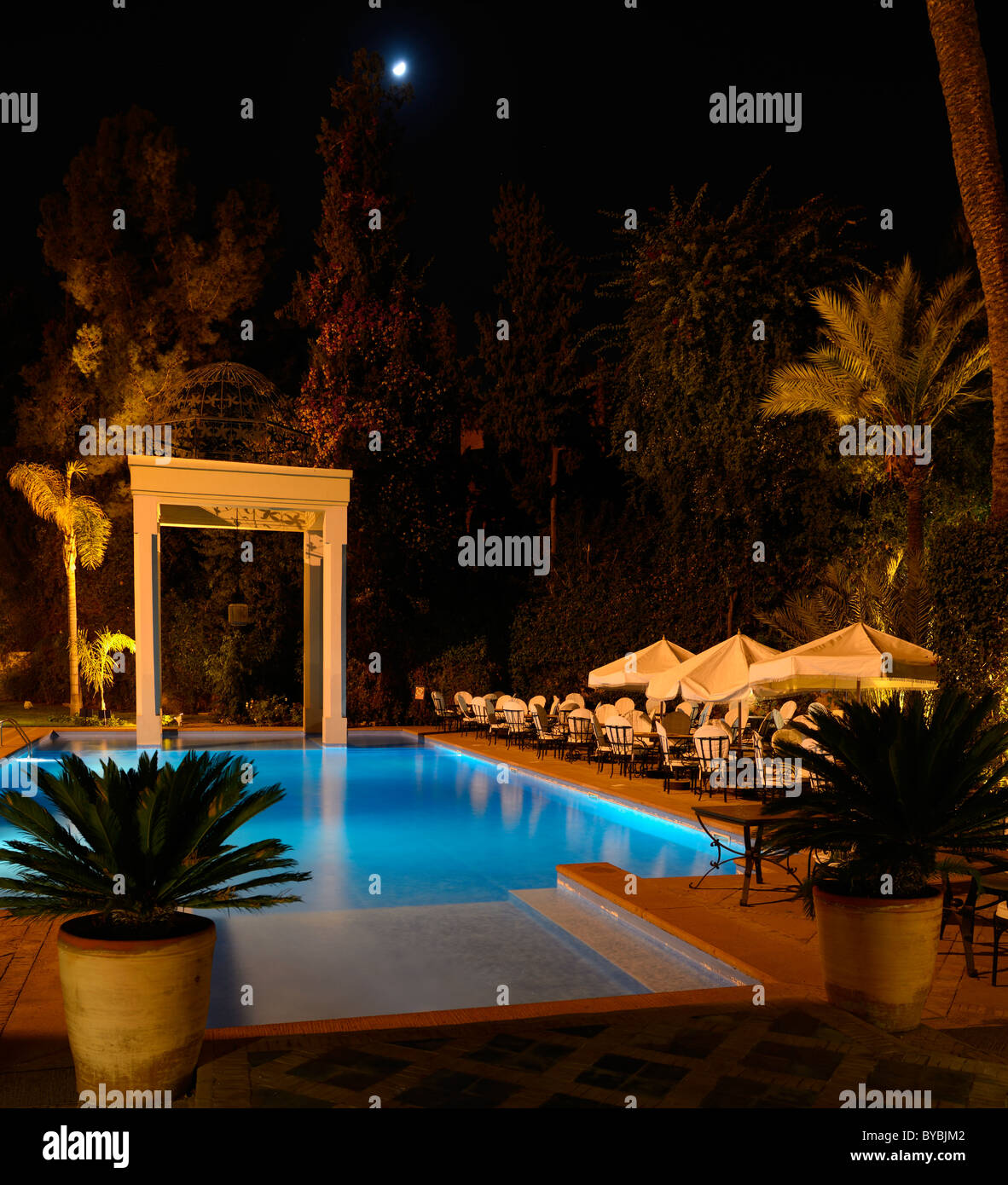 Moonrise over the swimming pool at Tichka Salam resort in Marrakesh Morocco at night Stock Photo