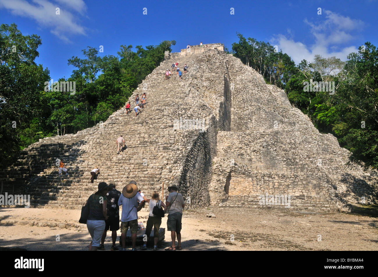Tourists climbing the Nohoch Mul pyramid at the Mayan ruins of Coba Yucatan Mexico Stock Photo
