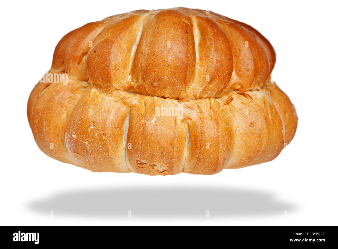 Photo of a white cottage loaf of bread, isolated on a white background with floating shadow. Stock Photo