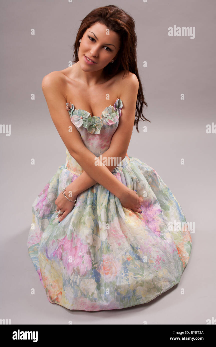 Studio portrait of a cute young lady in colorful dress Stock Photo - Alamy