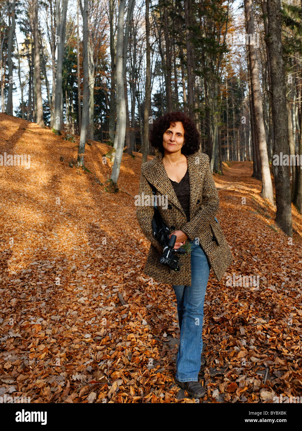 Portrait of a young woman walking in the forest Stock Photo - Alamy