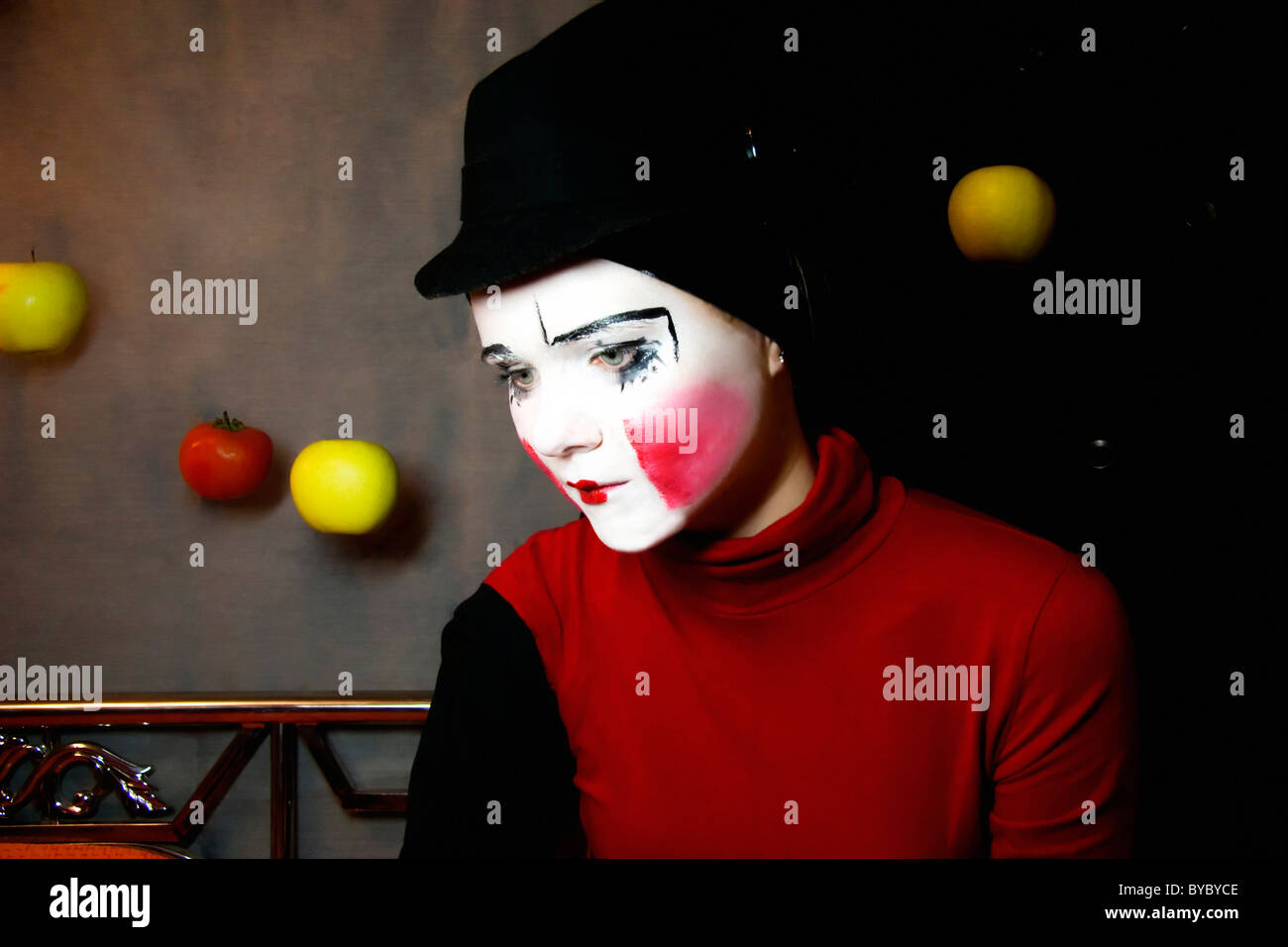 Portrait of the sad mime in a hat with apples Stock Photo - Alamy