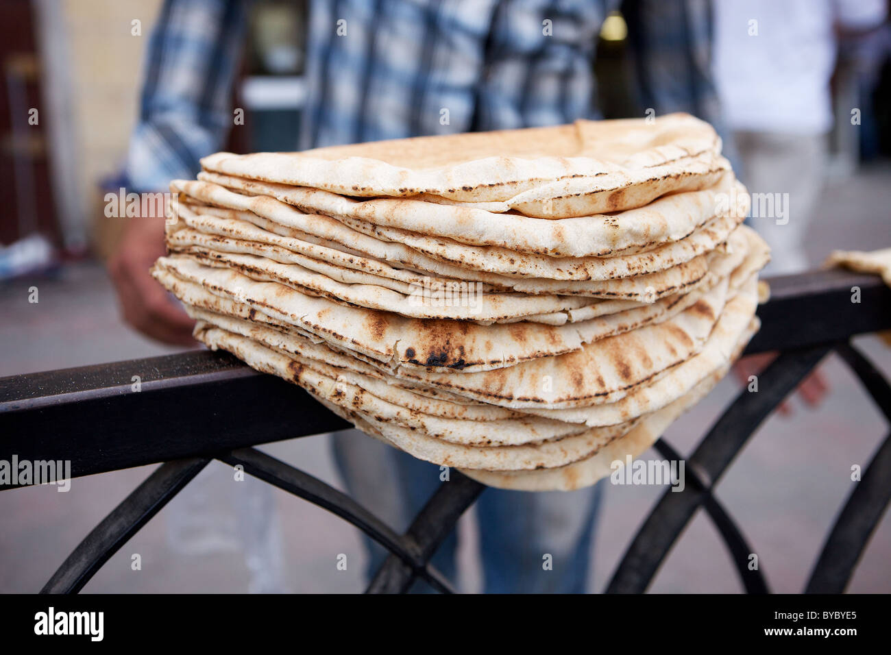 Freshly baked bread drying on railings on pavement in centre of Aleppo ...