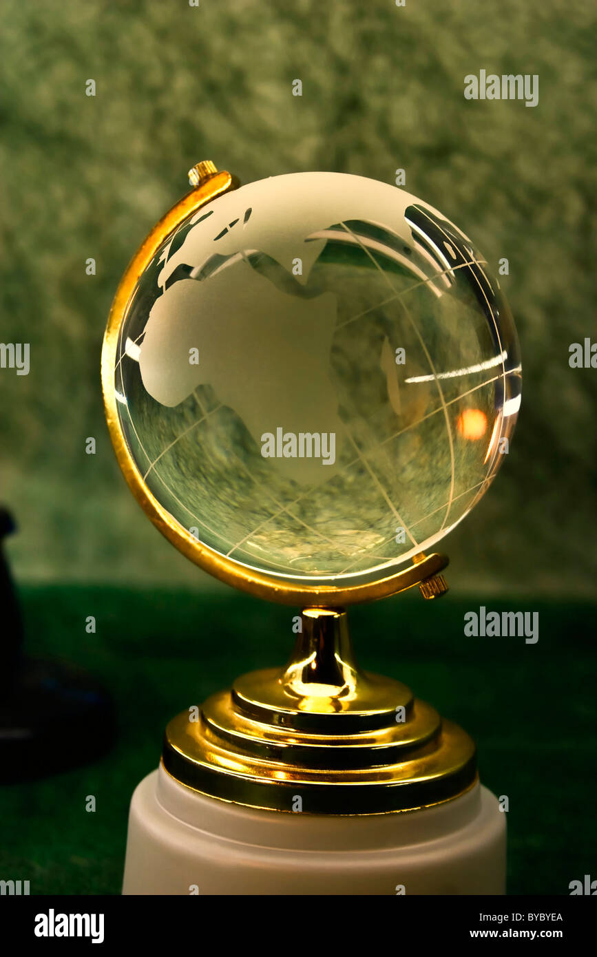 glass globe on a green background Stock Photo