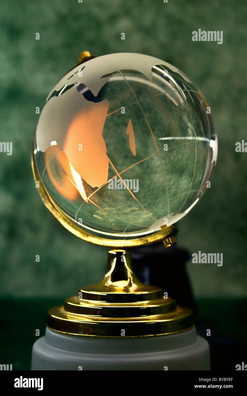 glass globe on a green background Stock Photo