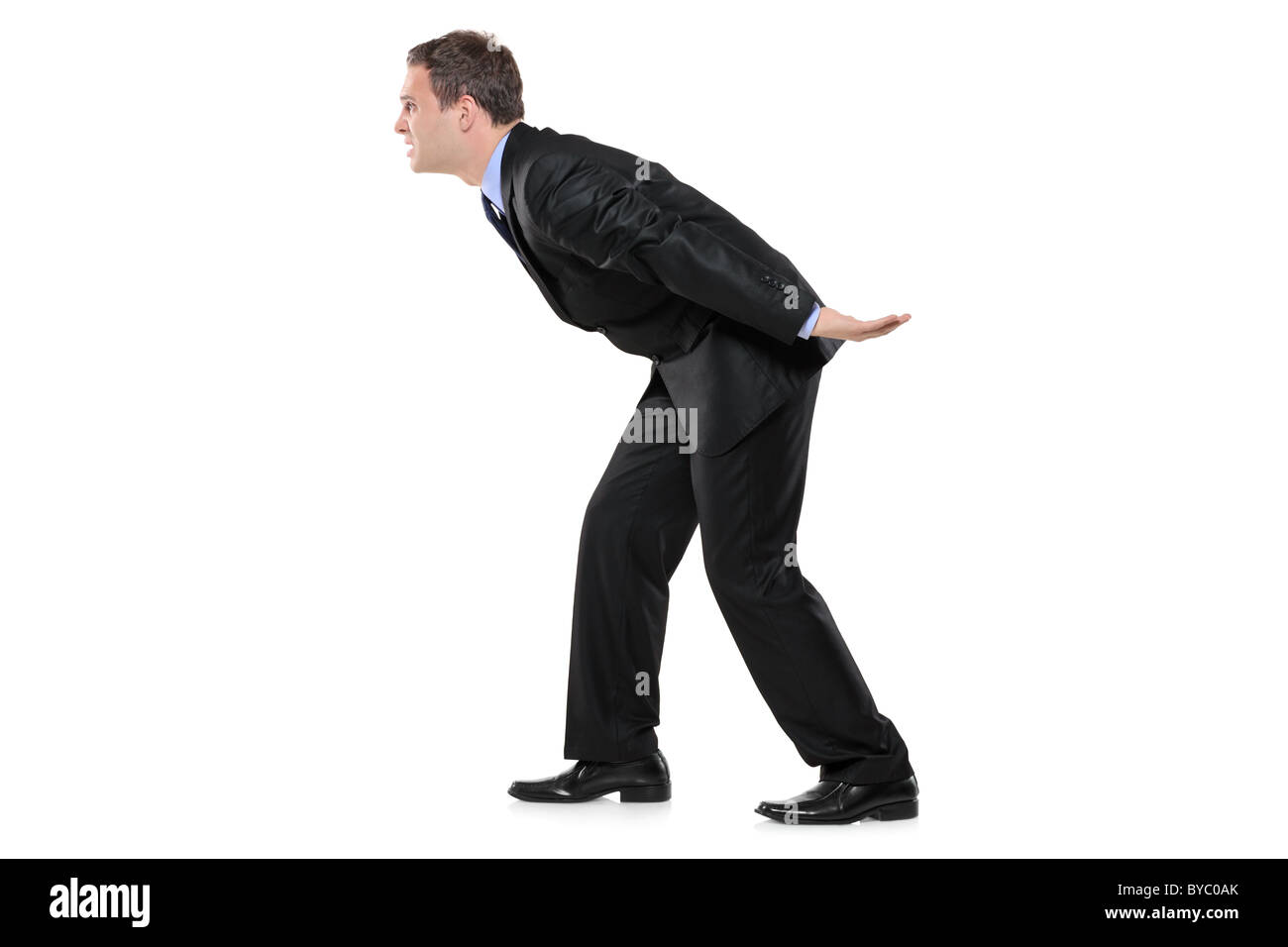 Full length portrait of a businessman carrying something imaginary Stock Photo