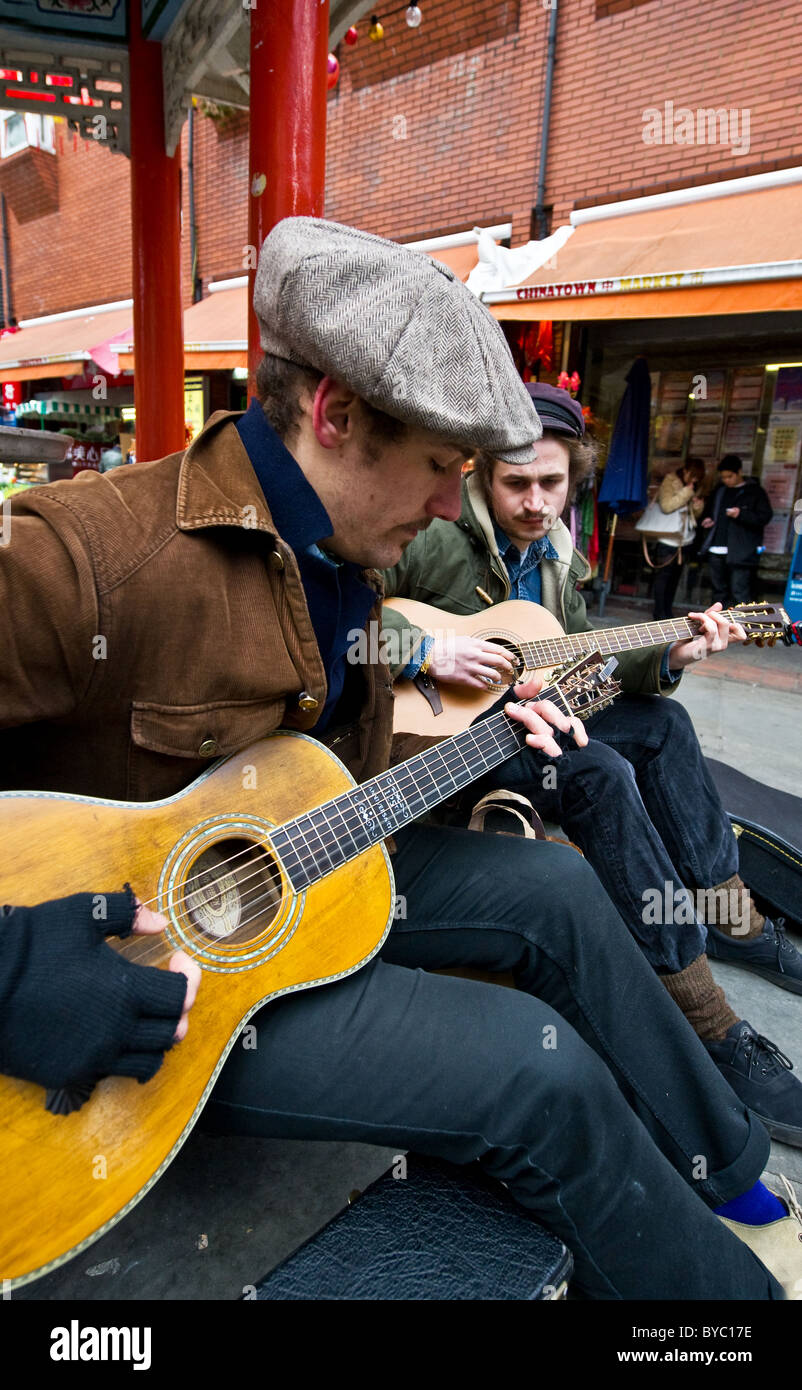 Two men playing guitars in a street in London.  Photograph by Gordon Scammell Stock Photo