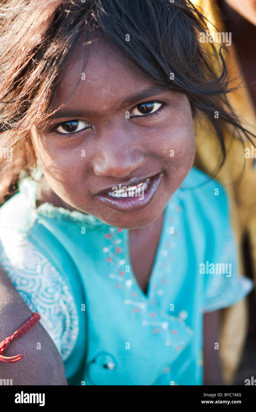 Happy young poor lower caste Indian street girl smiling. Andhra Pradesh, India. Selective focus Stock Photo