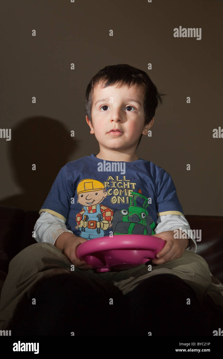 young boy playing alone on Nintendo Wii Stock Photo