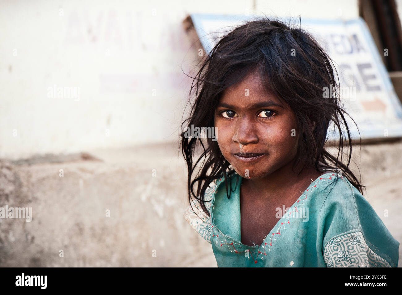Happy young poor lower caste Indian street girl smiling. Andhra Pradesh, India. Selective focus with copy space Stock Photo