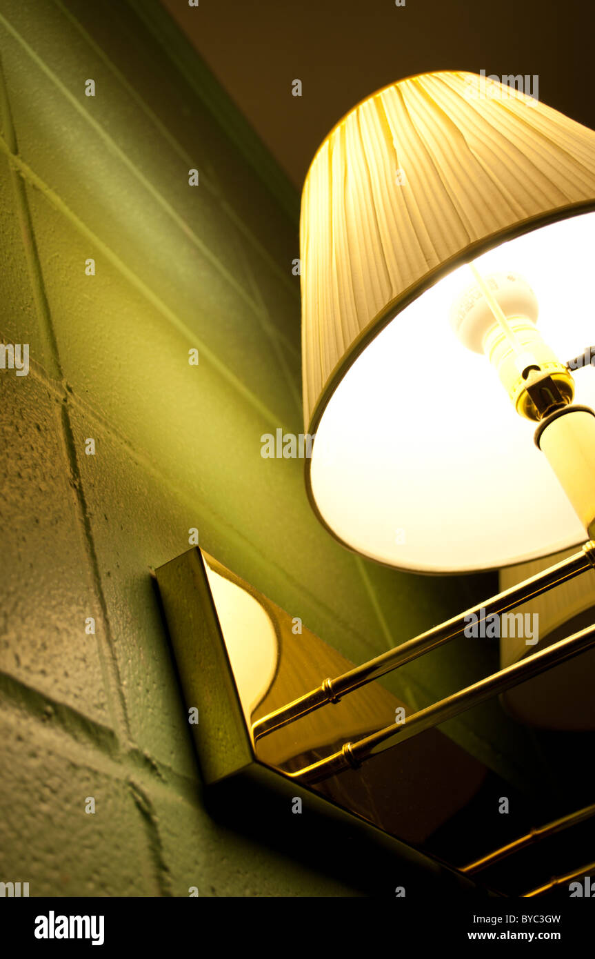 A lamp on the wall of a cheap motel room. Stock Photo
