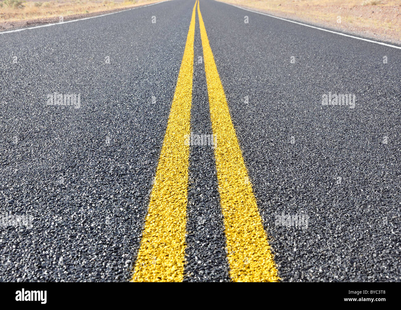 Closeup of the yellow road dividing line Stock Photo