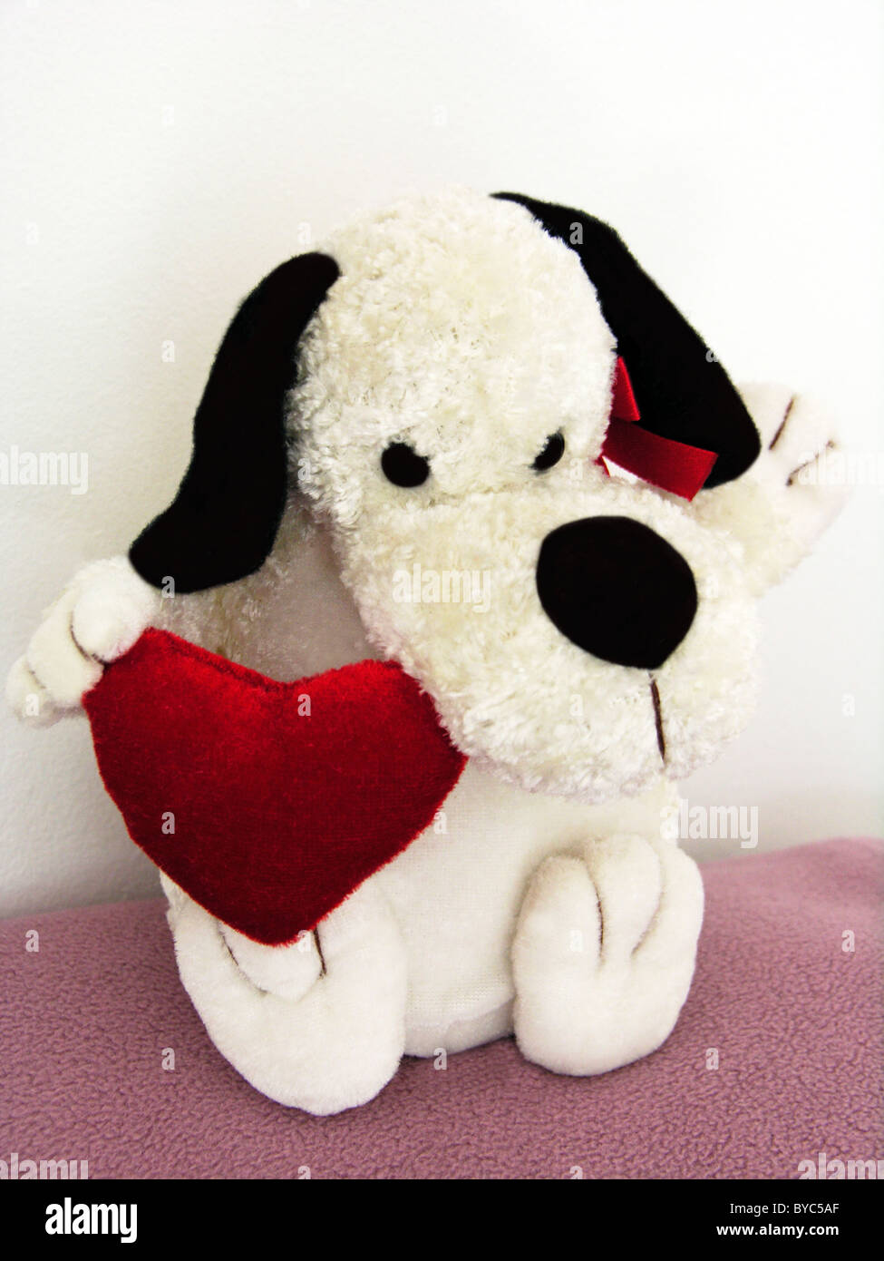 cute cuddly toy dog with a heart of love Stock Photo