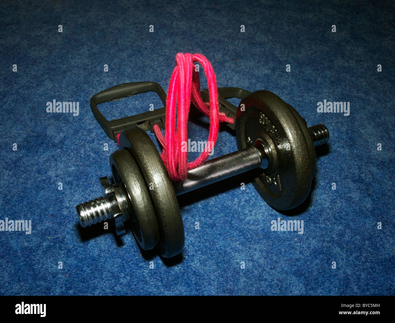Fitness: Expander and dumb bell Stock Photo