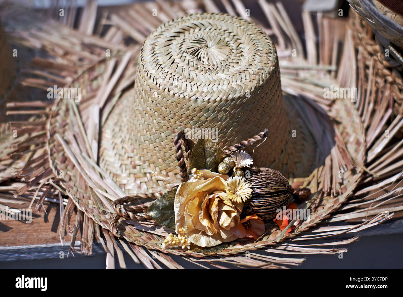 Tattered Straw hat and embellishments at a tropical location. Thailand S. E. Asia Stock Photo