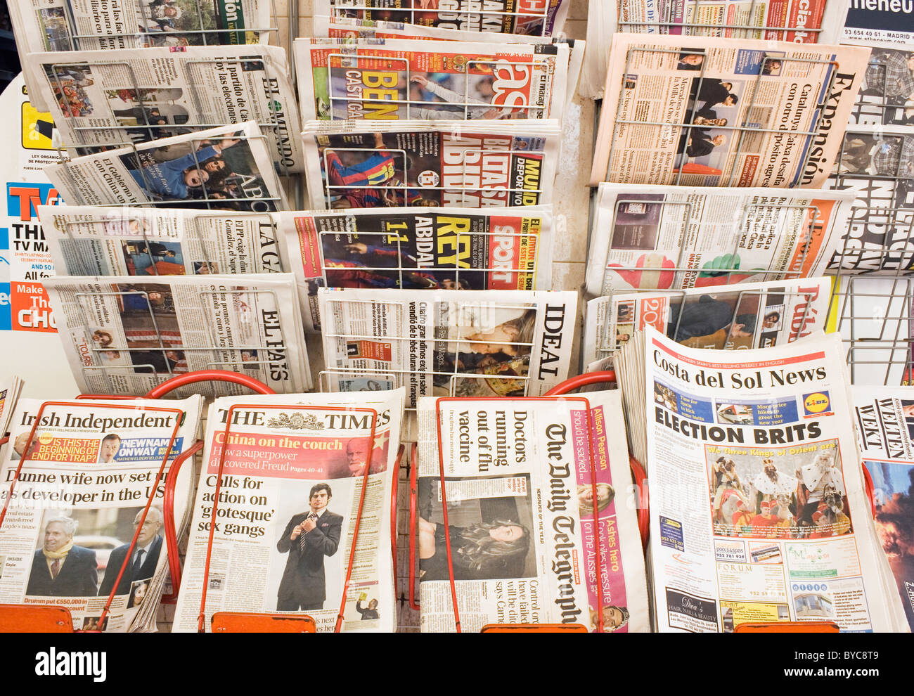 English and Spanish newspapers on sale outside shop in Fuengirola, Spain. Stock Photo