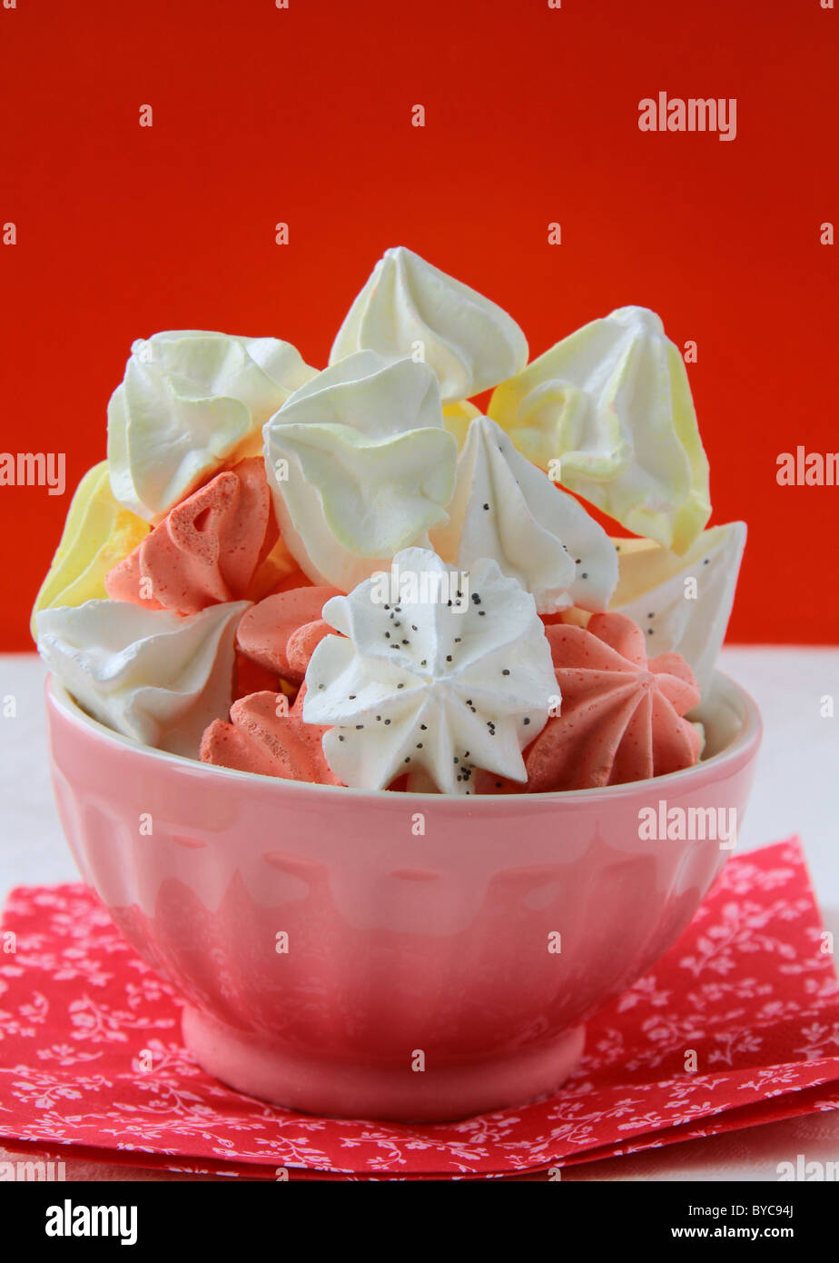 colorful meringue beze cookies in a cup on the table Stock Photo