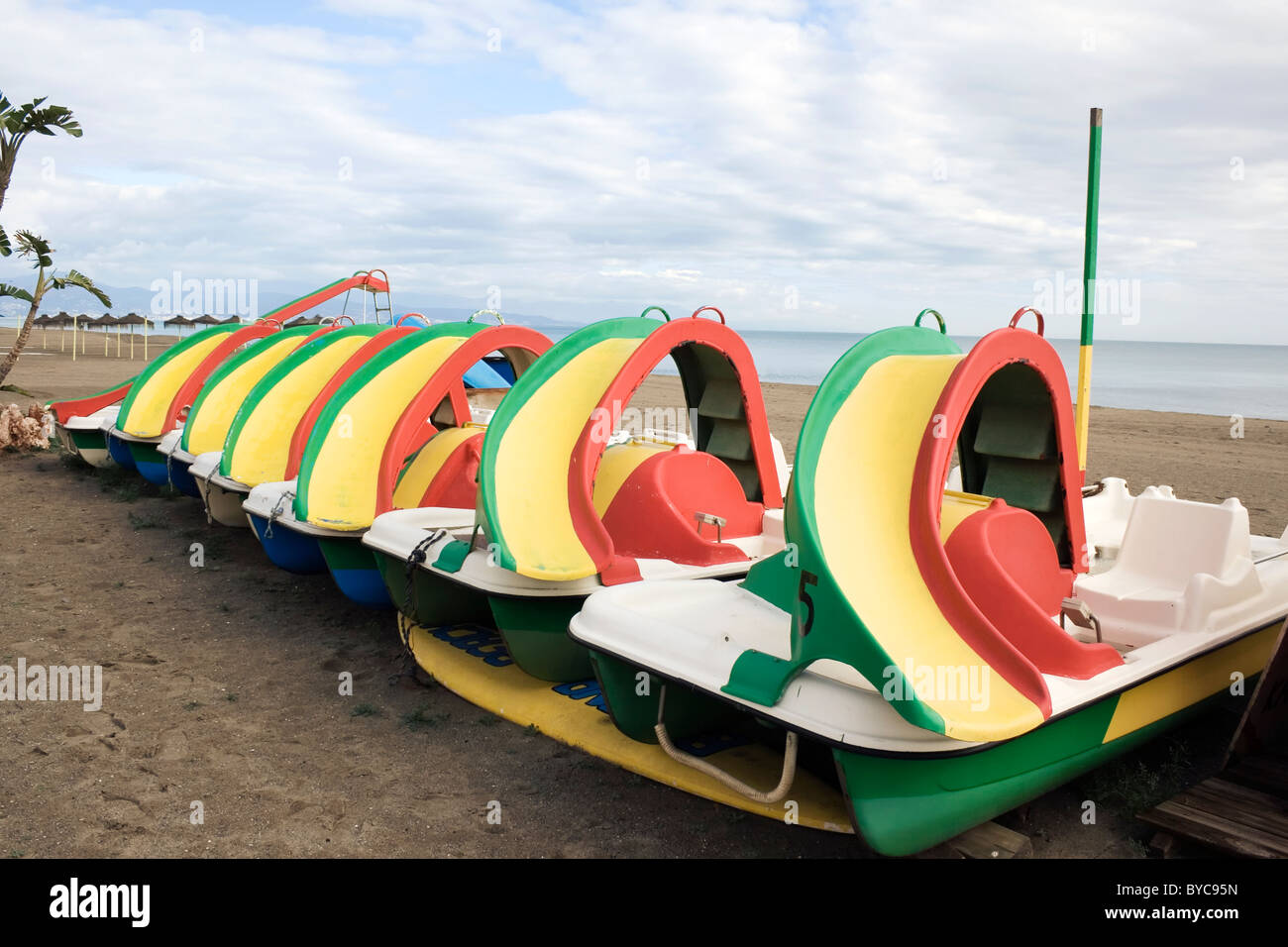 Row of coloured pedalo boats with slides on beach in Torremolinos