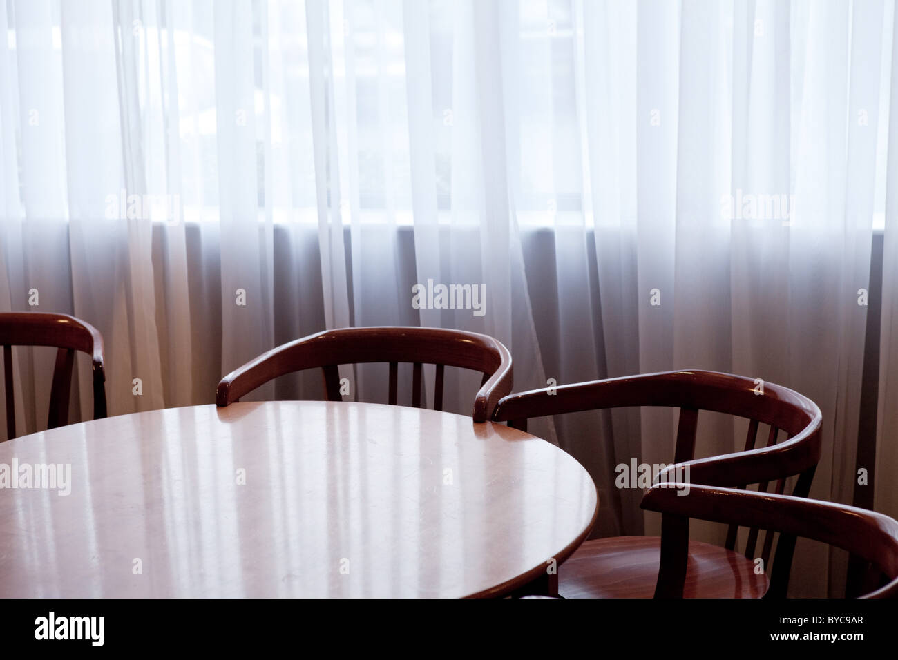 Empty chairs round a table in a hotel meeting room Stock Photo