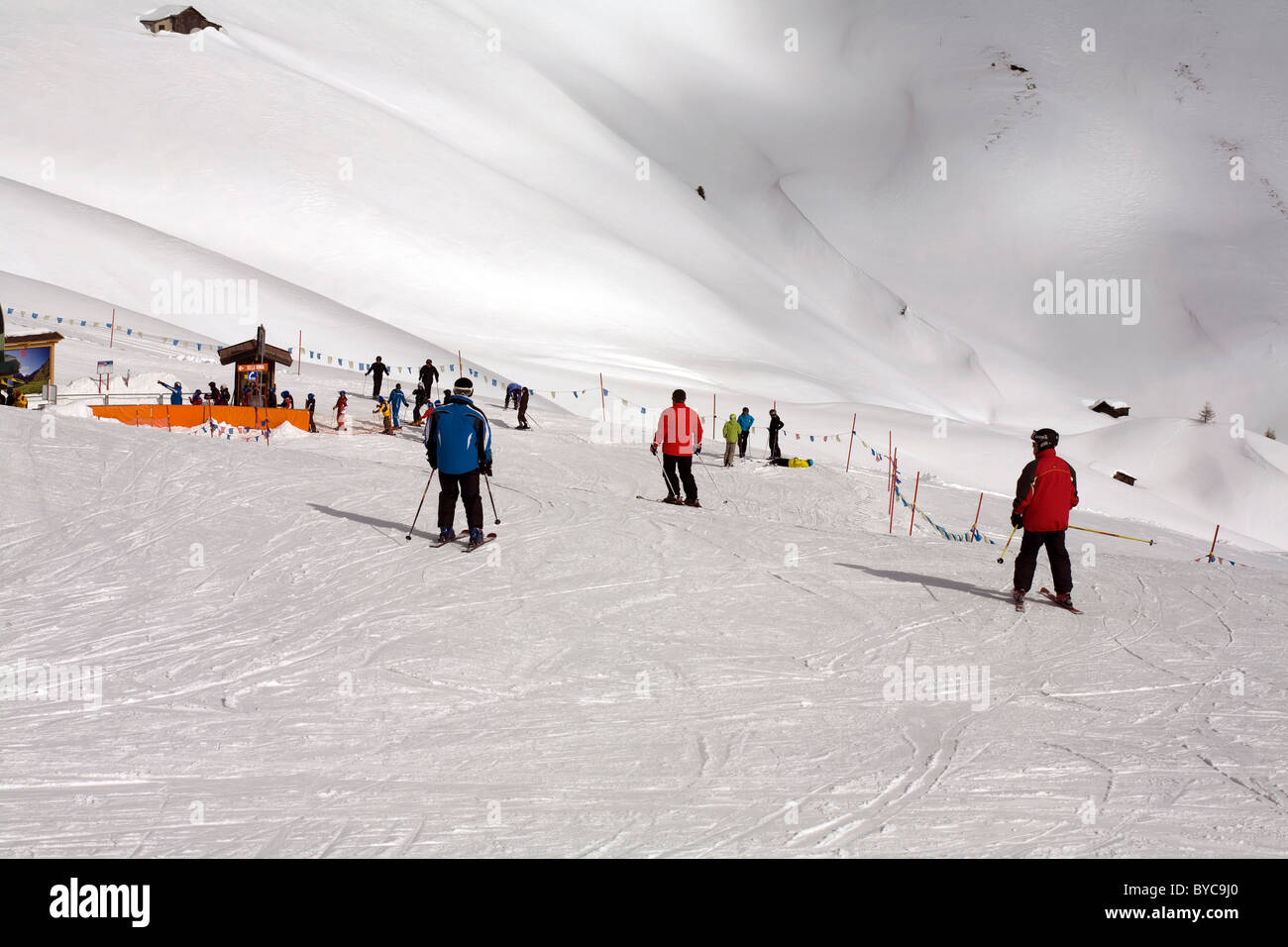 Skiers skiing on the pistes at The Passo Sella Sellajoch Selva Val gardena Dolomites Italy Stock Photo