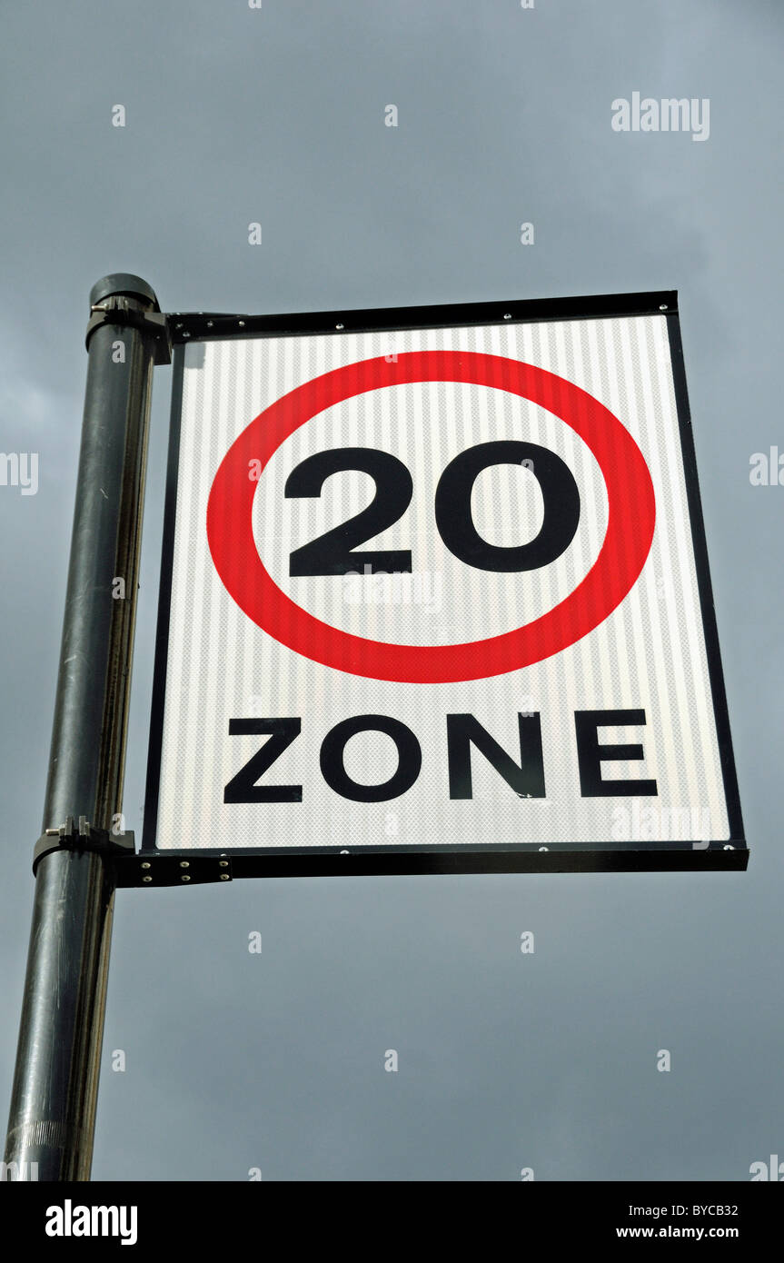 20 mile an hour traffic speed limit zone sign against sky Stock Photo