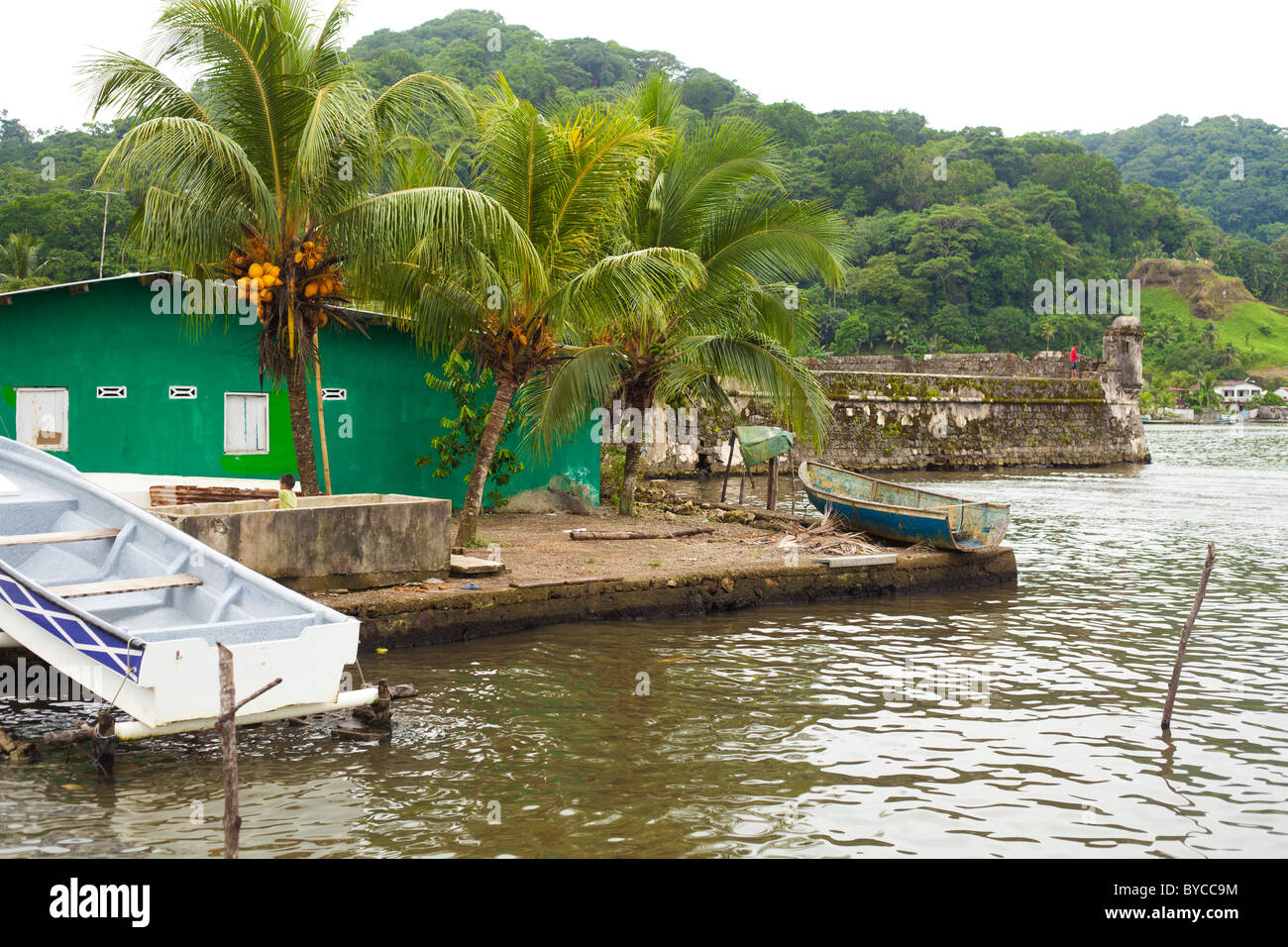 Bay and village scene in Portobelo, Panama with green houses, palm