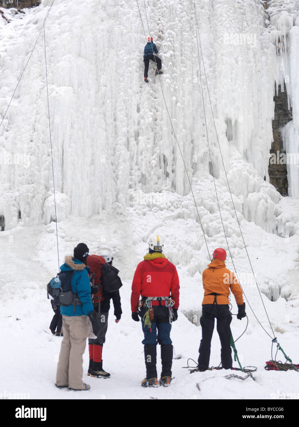 Group of ice climbers at a frozen waterfall. Wintertime scenic, Ontario, Canada. Stock Photo