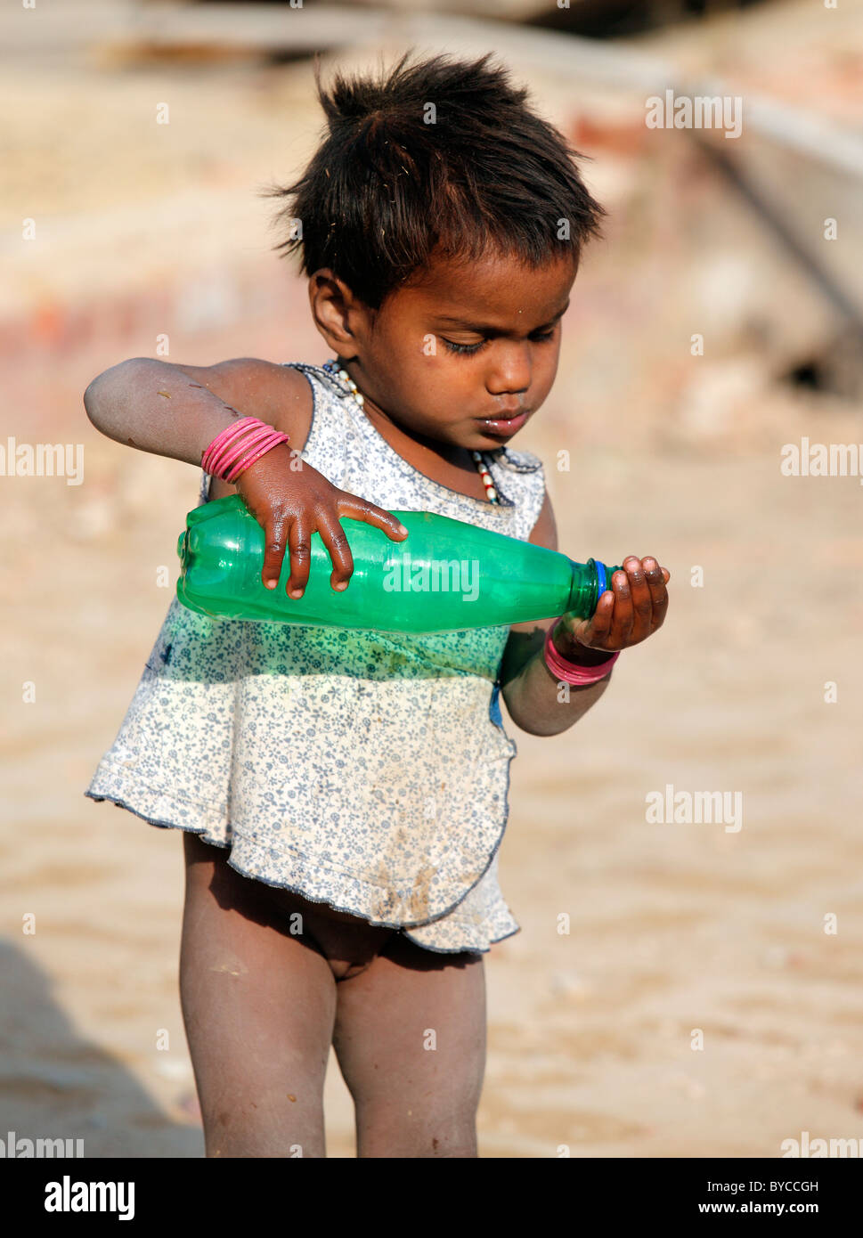 Kid,youngster,baby,construction site,happy,cheerful,prankster,enjoying,bottle,'bottle of water,drinking,baby Stock Photo