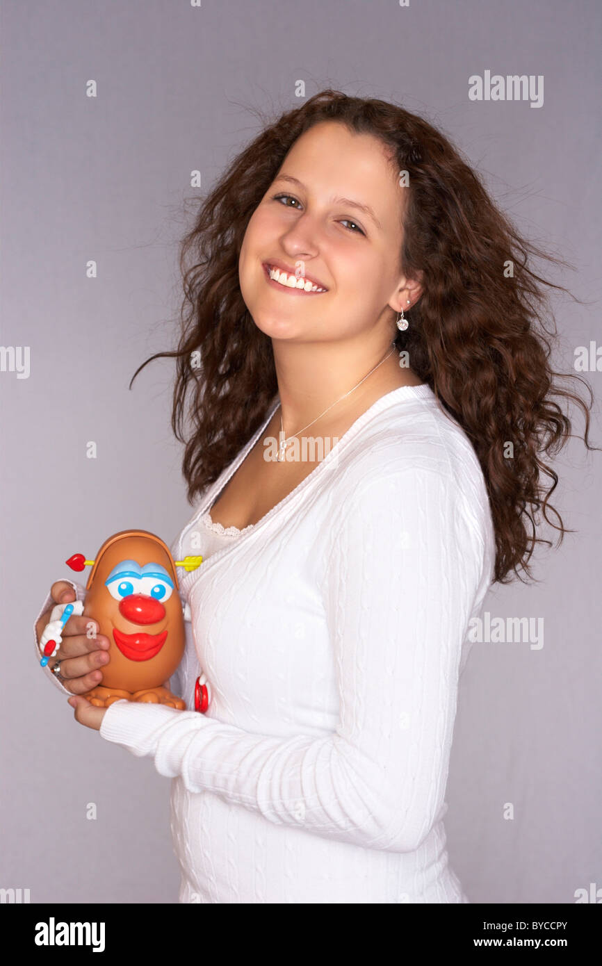 A teenage girl with long curly brown hair Stock Photo