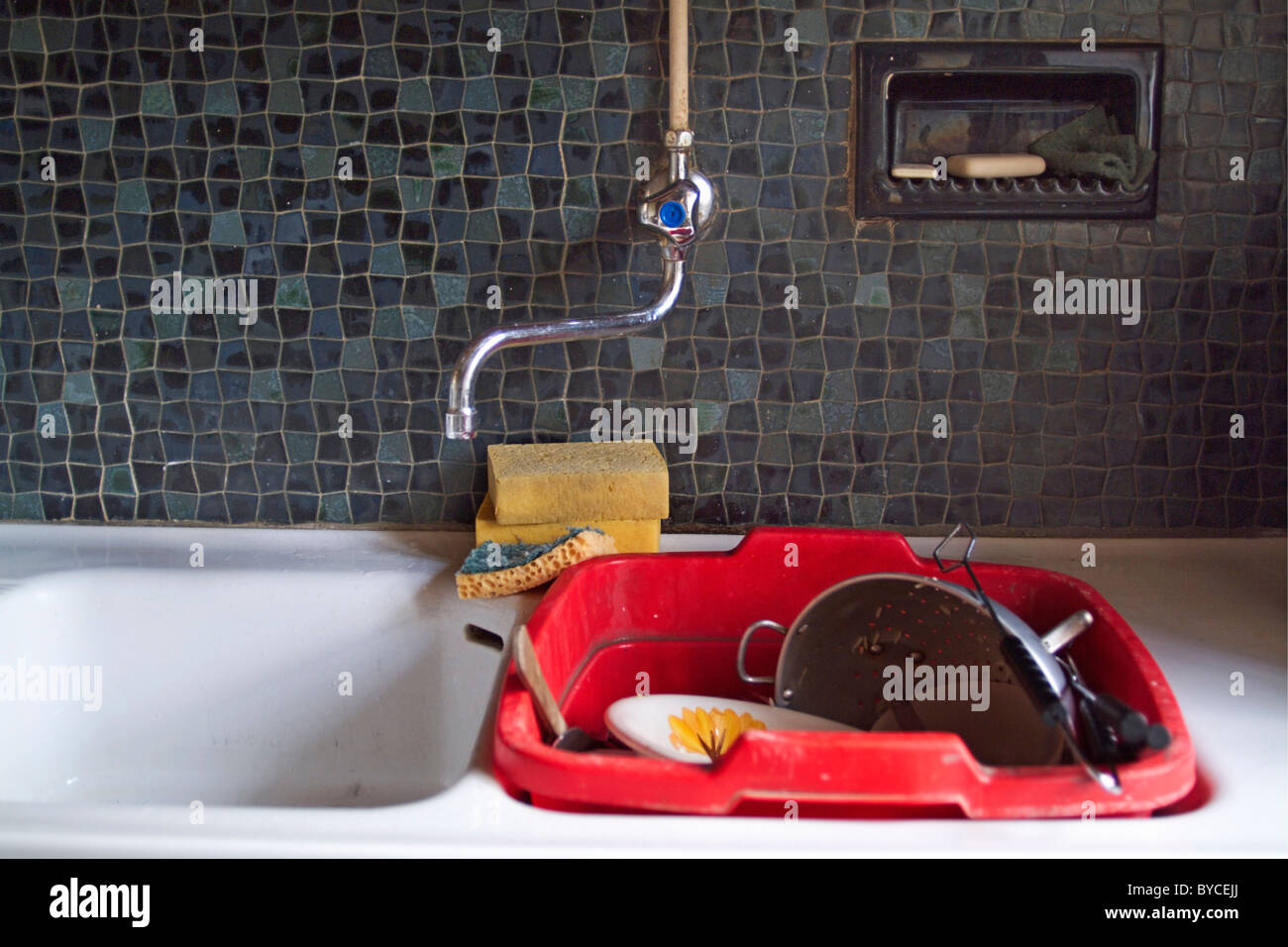 Dirty dishes soaking in a kitchen sink, France Stock Photo Alamy