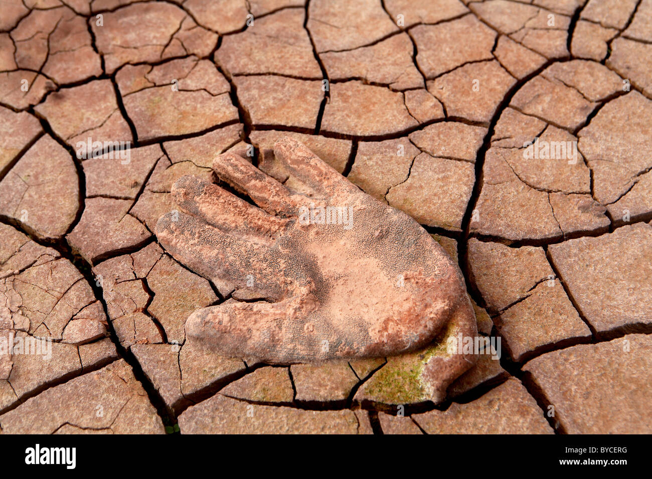 Workers safety glove in dried up mud Stock Photo Alamy