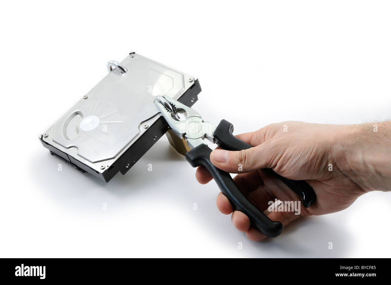 Hard disk locked under attack by one hand with pliers on a white
