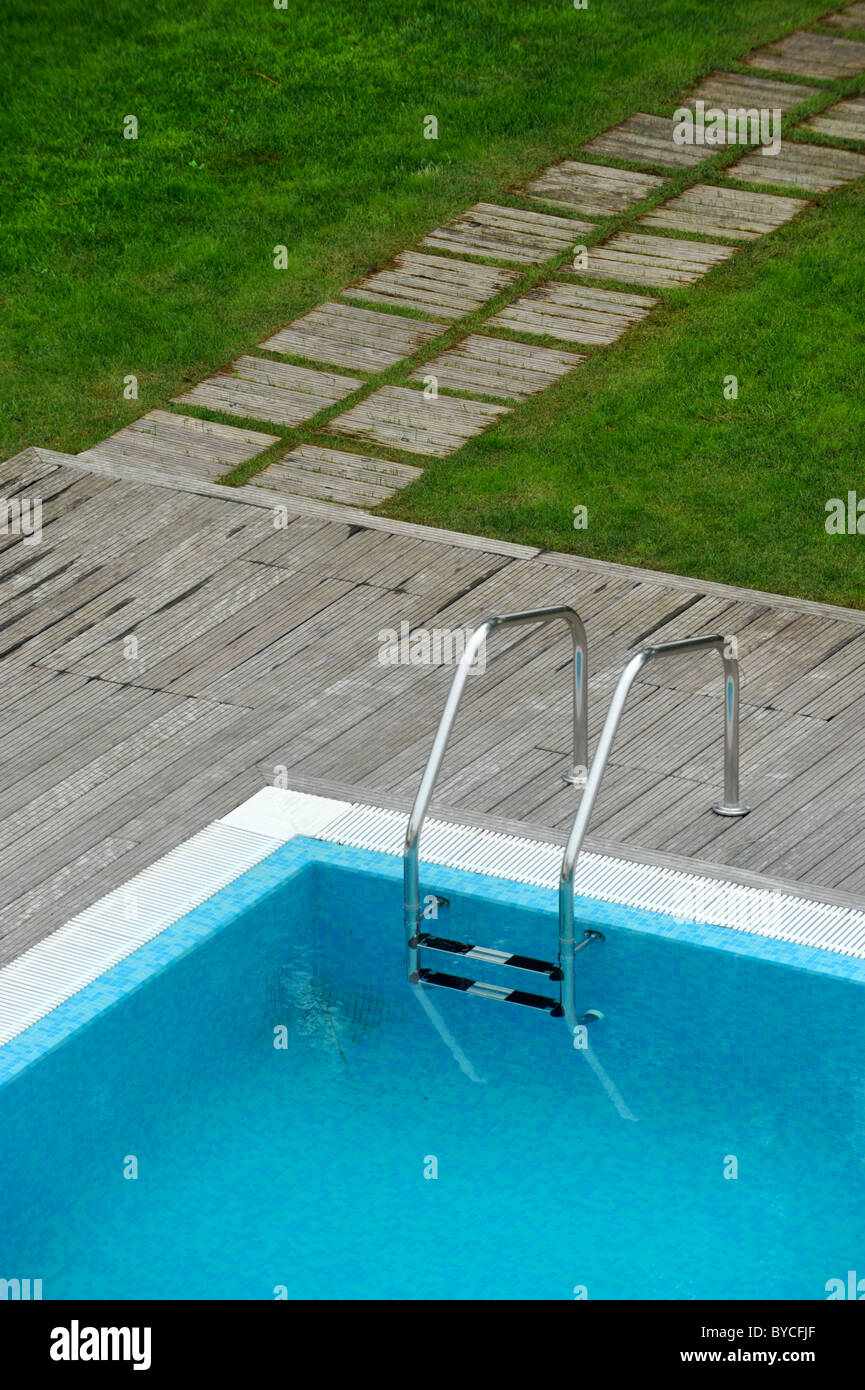 Aerial view of an outdoor swimming pool with wood deck and lawn Stock Photo