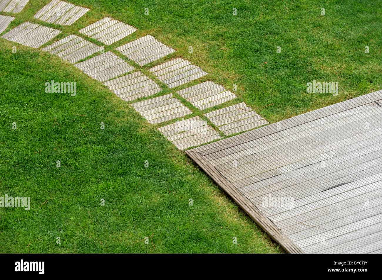 Detail of wood deck on garden lawn viewed from above Stock Photo