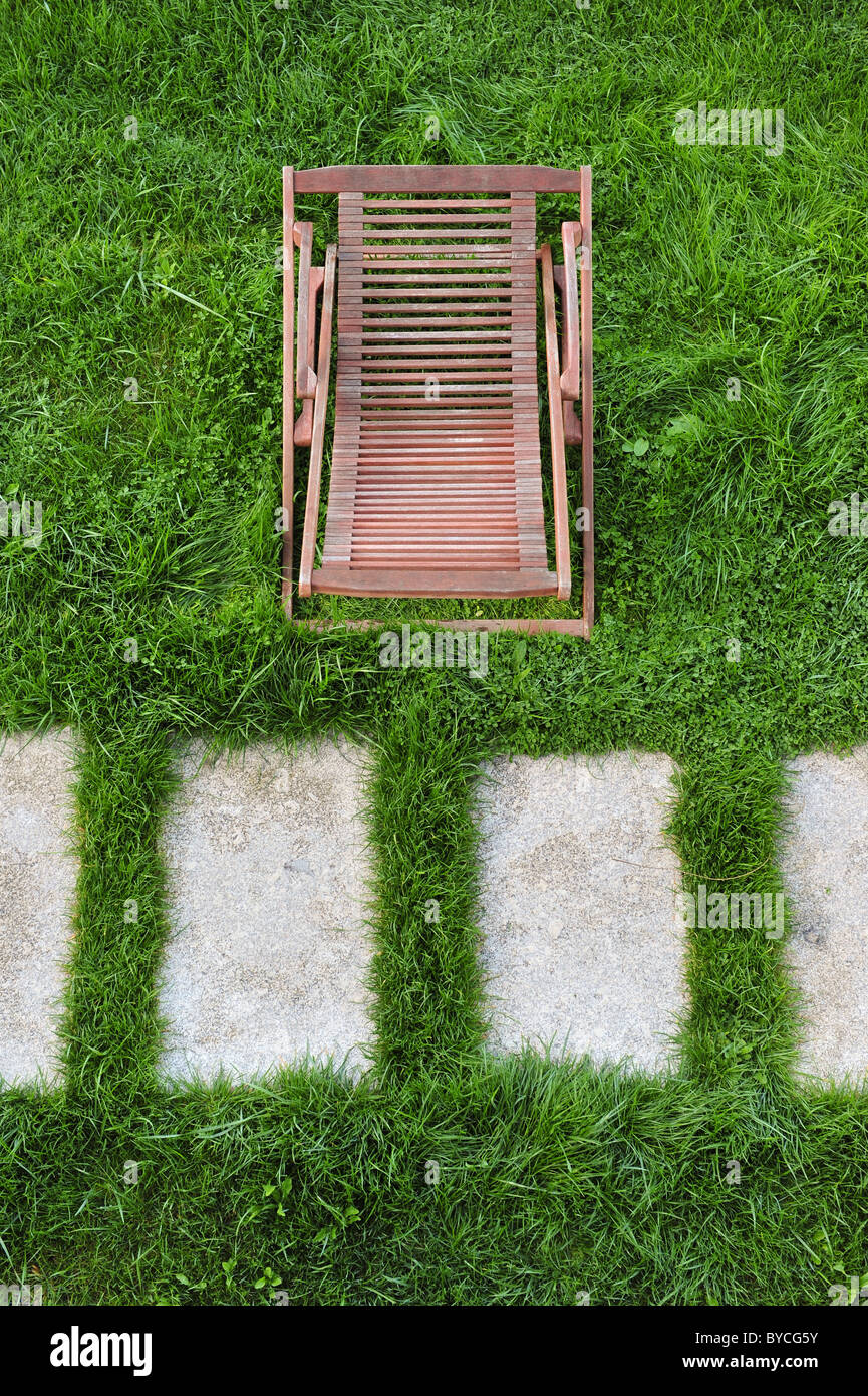 Wood lounge chair on lawn viewed from above Stock Photo