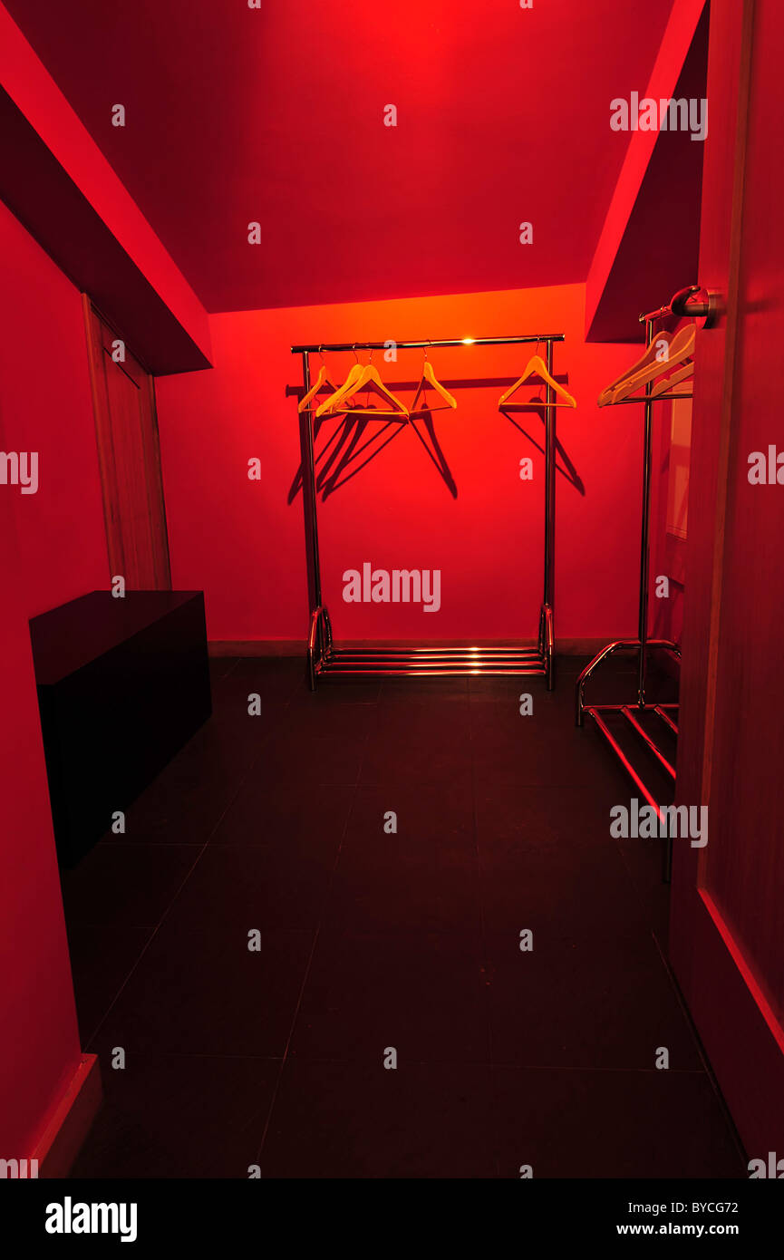 Empty walk in closet with hangers and red walls Stock Photo Alamy