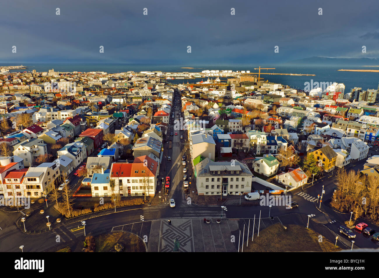 Reykjavík southwest Iceland birds eye view houses roofs color colored Iceland's biggest city main sun sunset road street way coa Stock Photo