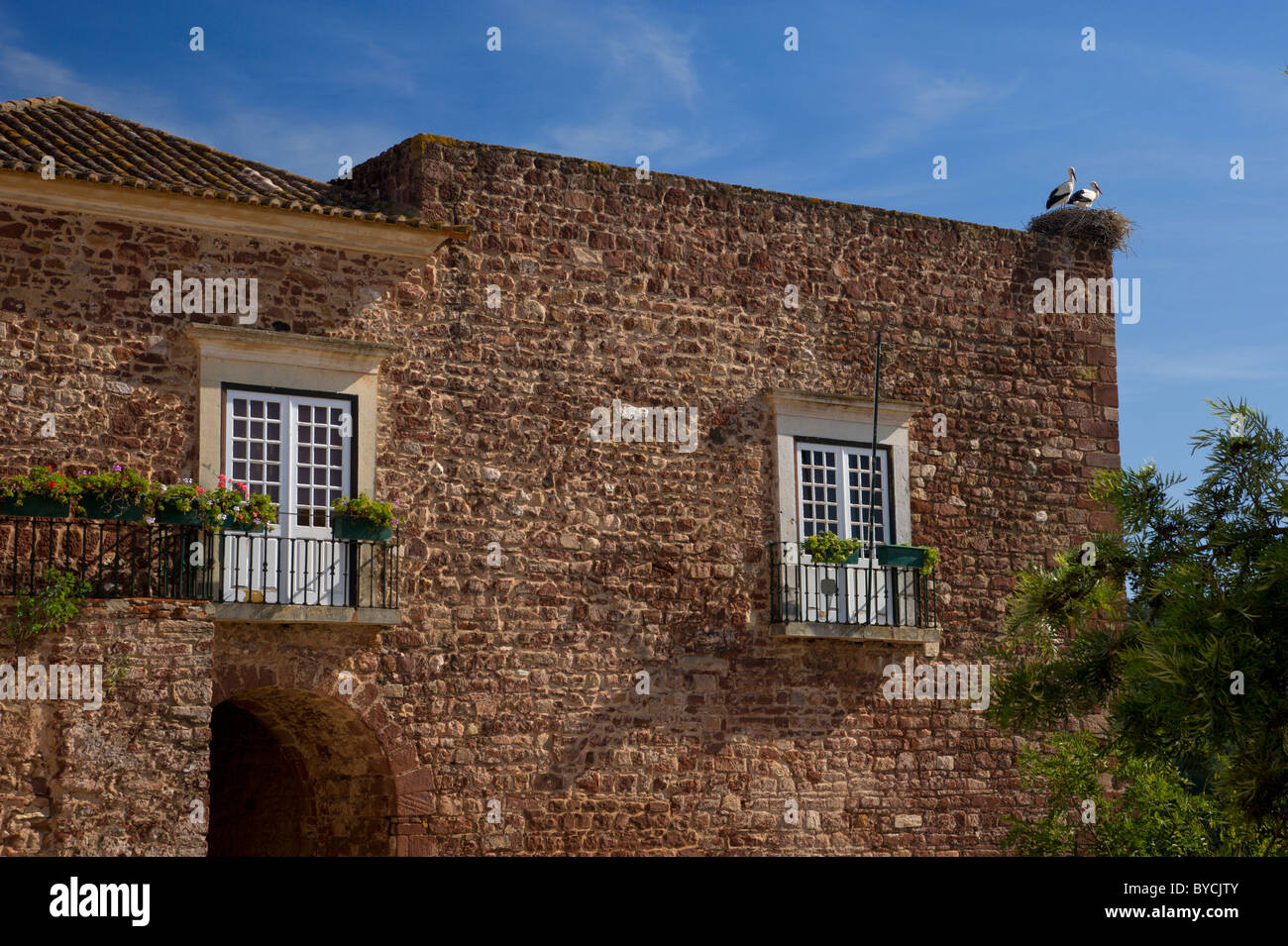 Portugal, the Algarve, medieval tower in the city walls, with a stork's nest on top Stock Photo