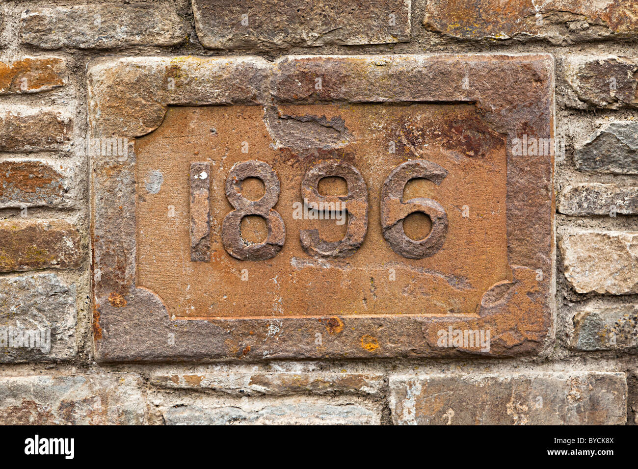 Date of 1986 in stone wall at the site of Six Bells colliery Blaenau Gwent Wales UK Stock Photo