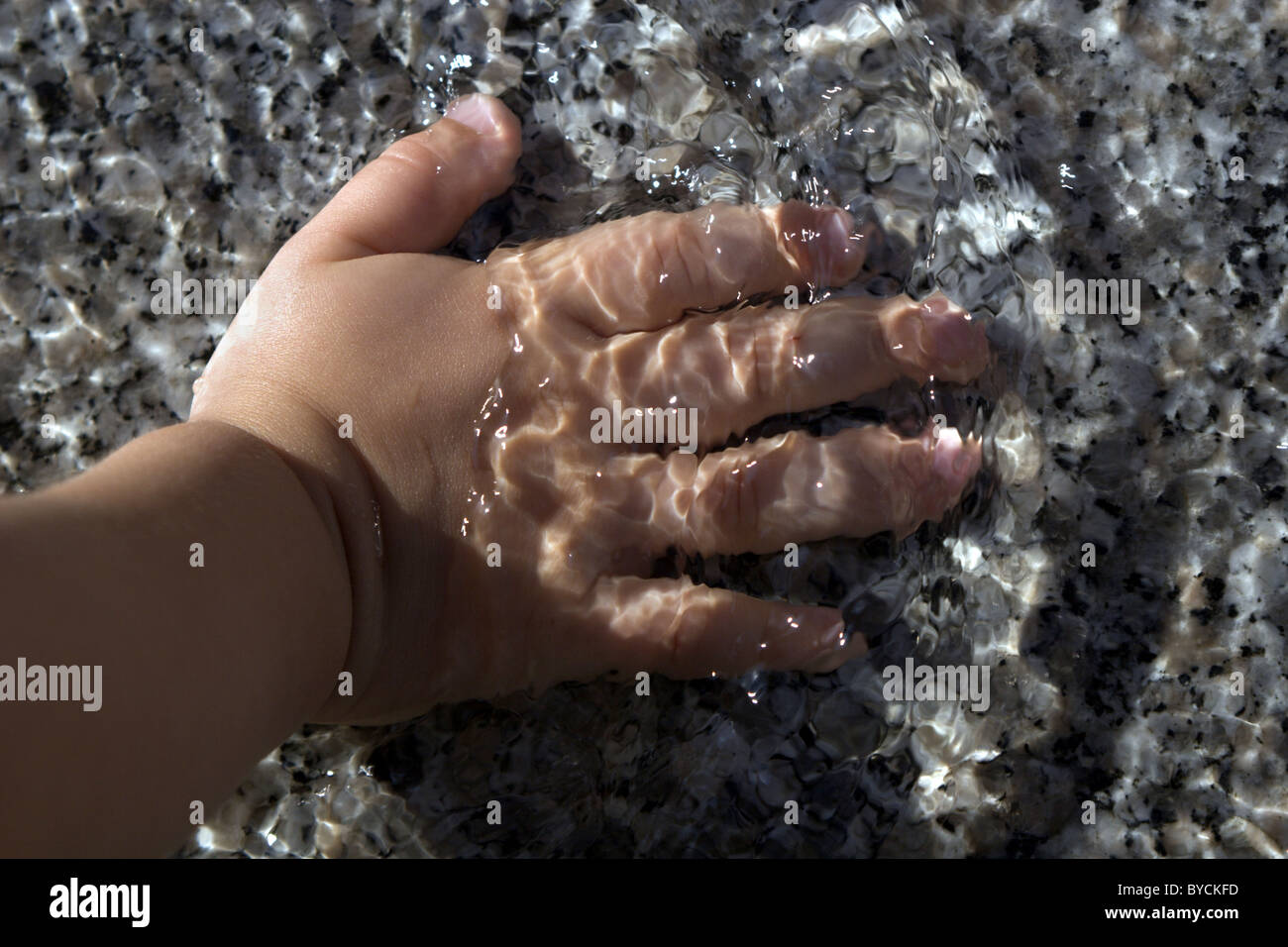 hand of little girl in the water Stock Photo