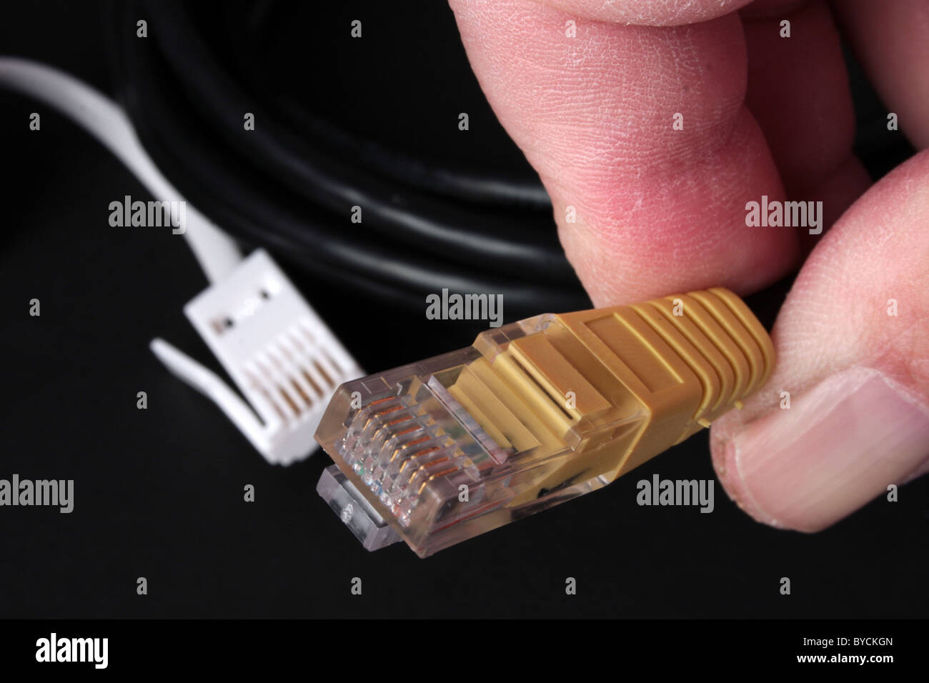UK telephone connector being held between thumb and forefinger Stock ...