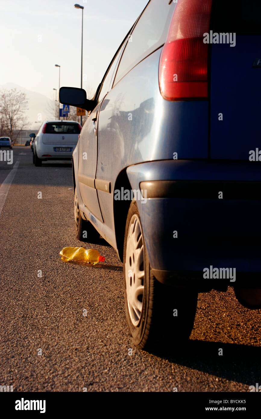 Parked car and plastic waste on an Italian road Stock Photo