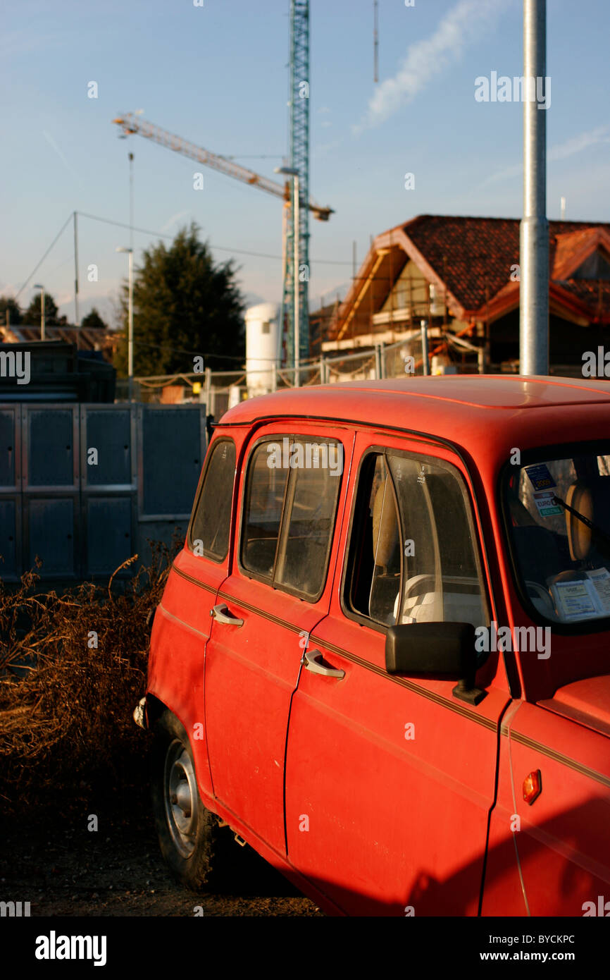 Red old car in Italy near a new building site Stock Photo