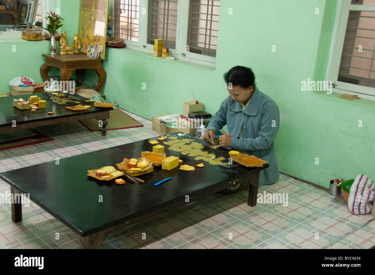 Myanmar (aka Burma), Mandalay. King Galon gold leaf Woman