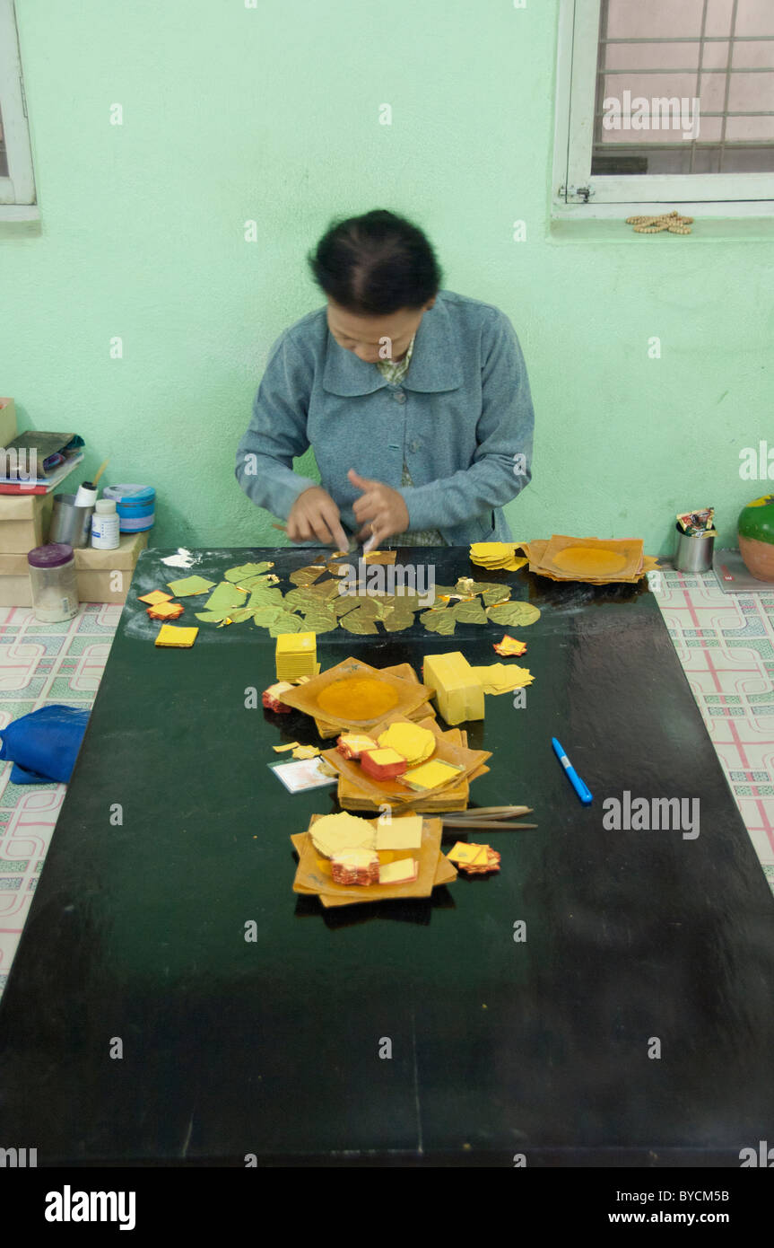 Myanmar (aka Burma), Mandalay. King Galon gold leaf Woman