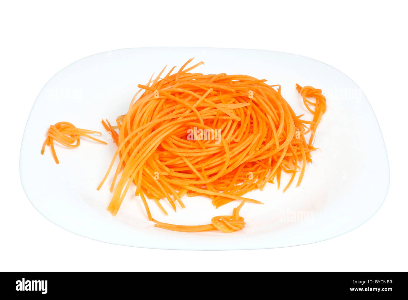 raw carrots julienne cutter on a plate isolated on white background Stock Photo