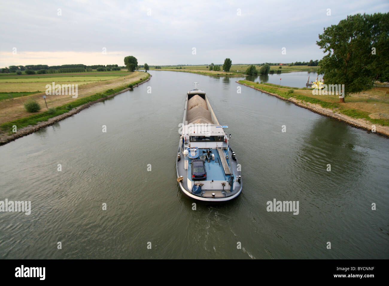 Cargo ship shipping gravel on the IJssel river in The Netherlands Stock Photo