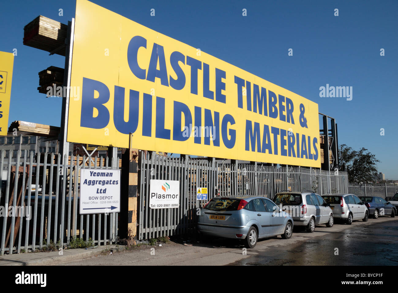A large sign advertising the Castle Timber and Building Materials, Horn Lane, London, UK. Stock Photo