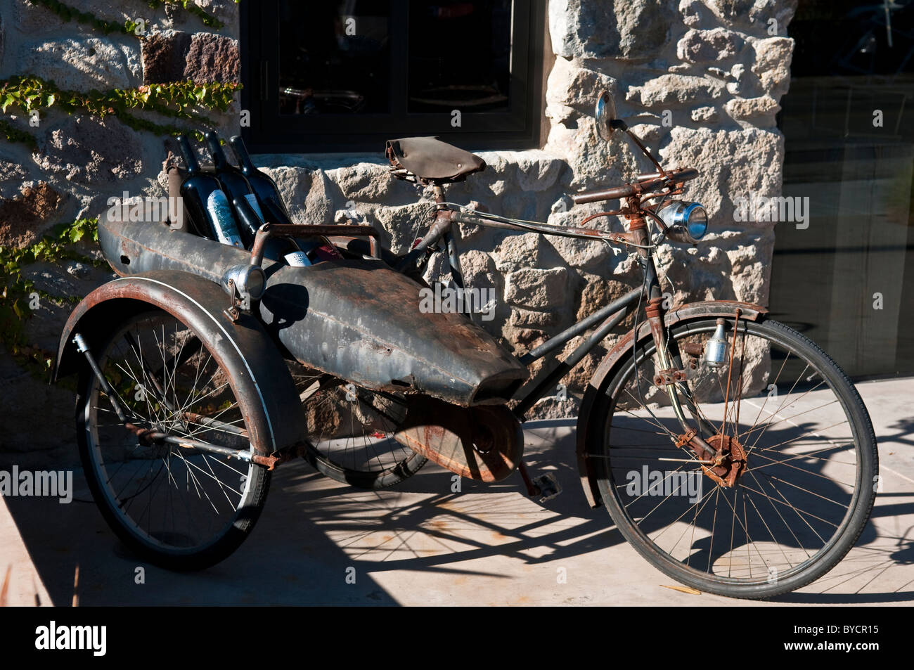 Ancient bicycle with sidecar and wine bottles Stock Photo
