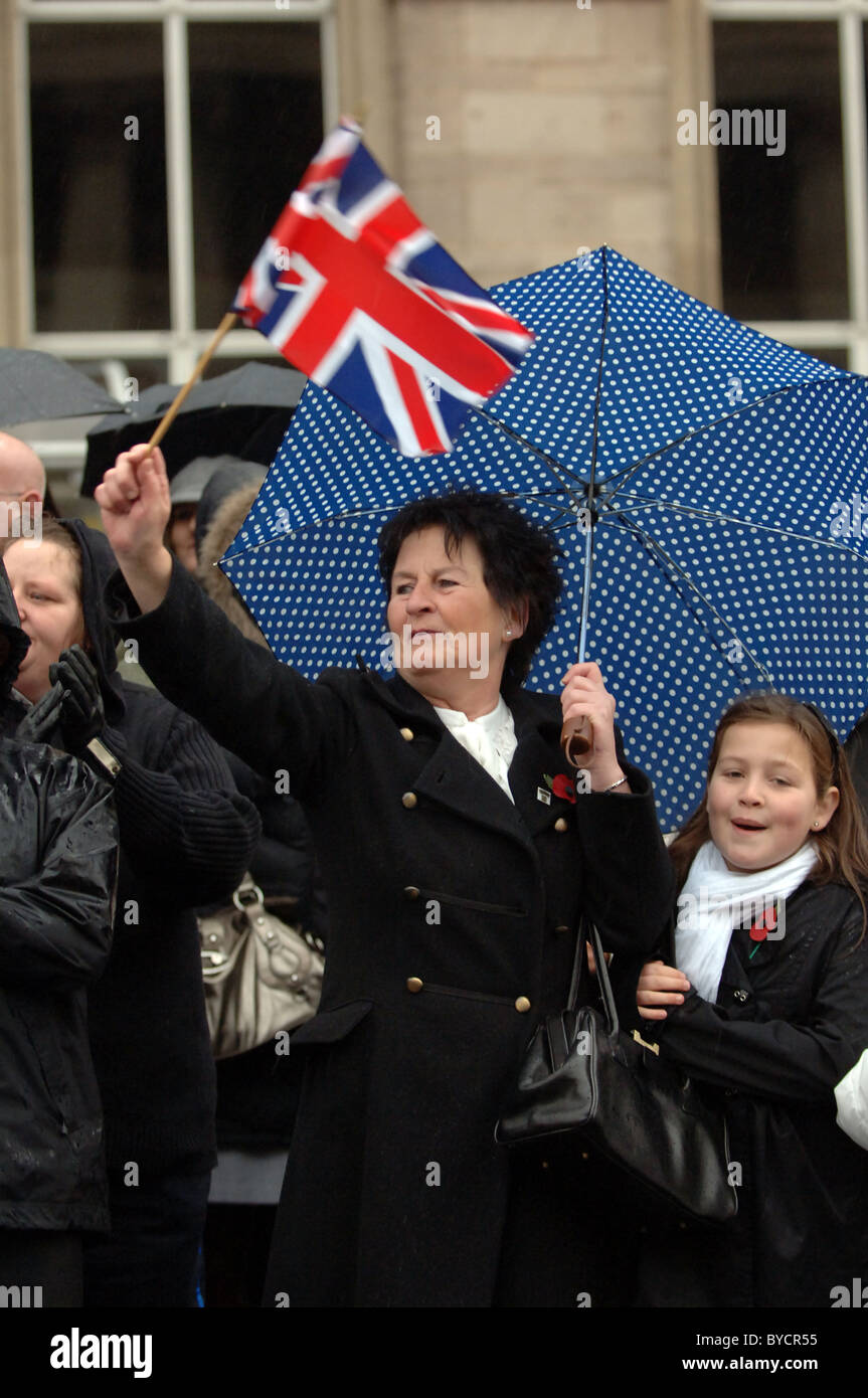 A women waving a Union Jack flag in a street celebration. Stock Photo